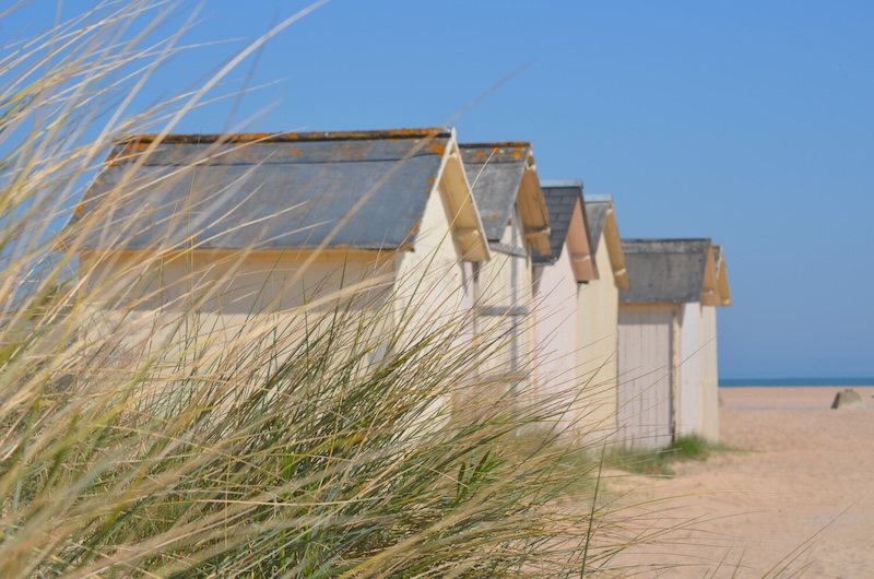Beach huts along Riva Bella beach
