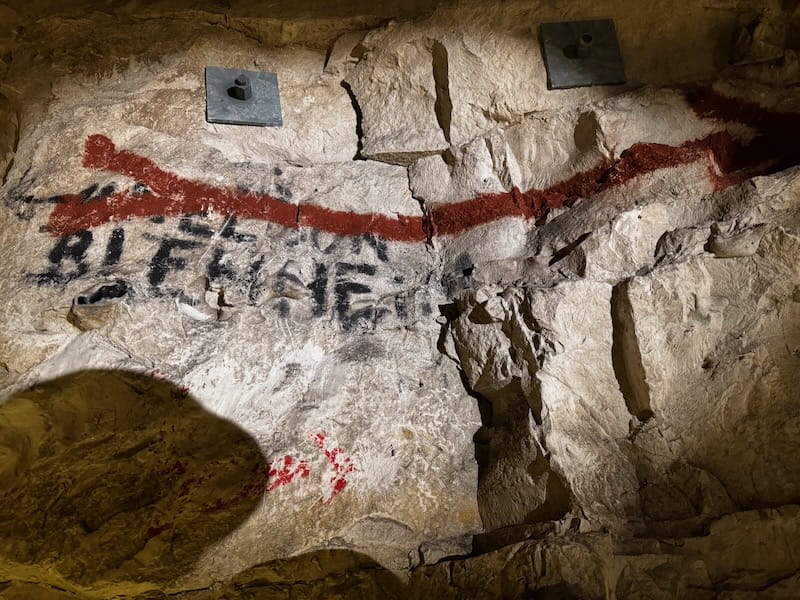 Rock in the Wellington Tunnels with the name Blenheim painted and an arrow