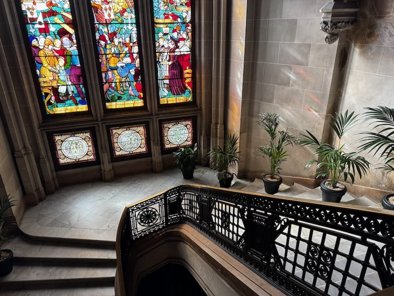 Majestic staircase and stained glass windows inside City Hall of Calais, France