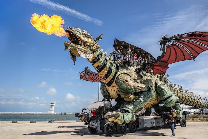 Calais dragon breathing fire and carrying passengers