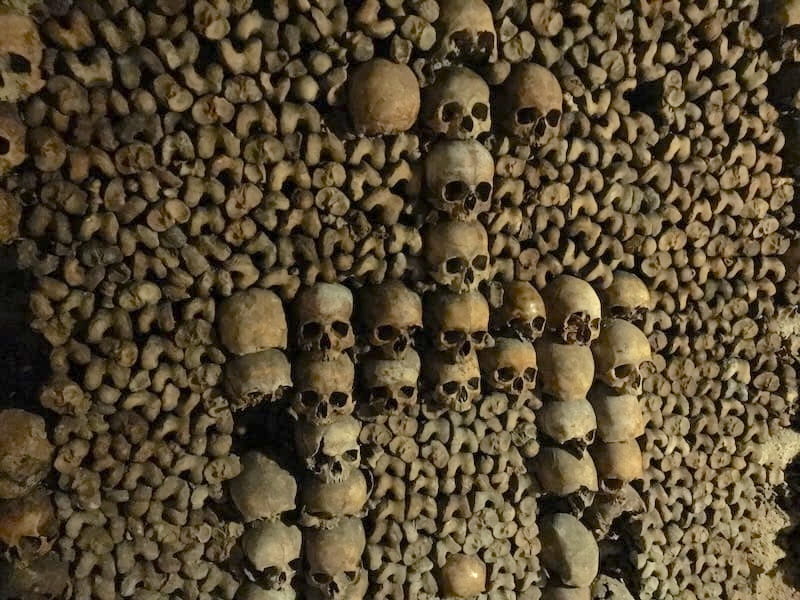 Bones stacked in Paris Catacombs