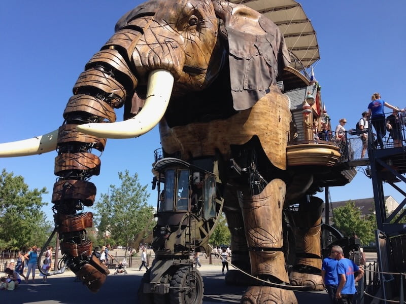 Mechanical elephant being ridden by visitors in Nancy - an easy ride with train travel, France