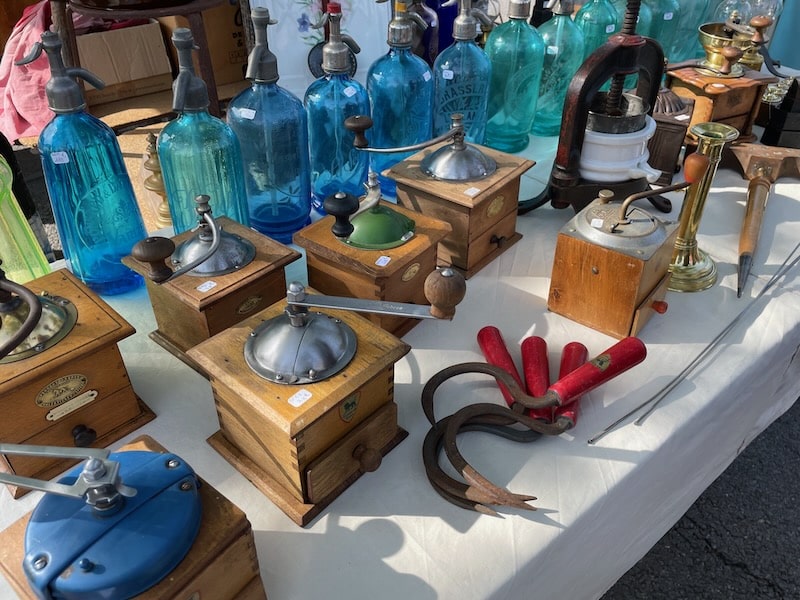 Table with antiques at brocante in Isle-sur-la-Sorgue in Provence