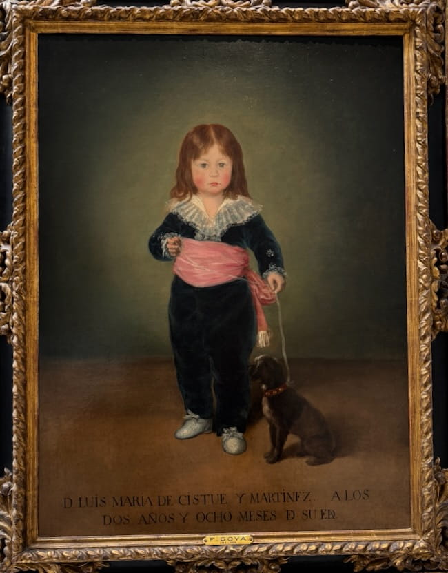 Goya portrait of a young boy in a blue velvet suit, with a small dog beside him