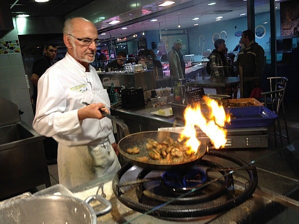 Sauteeing frogs legs at the Halles Paul Bocuse in Lyon
