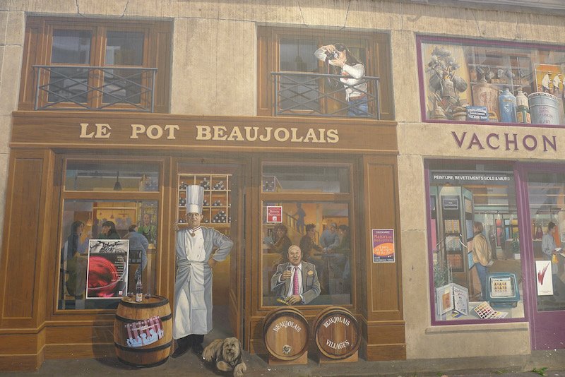 One of the most fun things to do in Lyon France is visit its many outdoor murals, like this one about Beaujolais wine