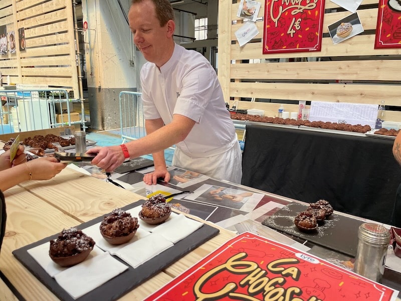 Pastry chef serving a customer at the Lyon Street Food Festival Pastry chef serving a customer at the Lyon Street Food Festival