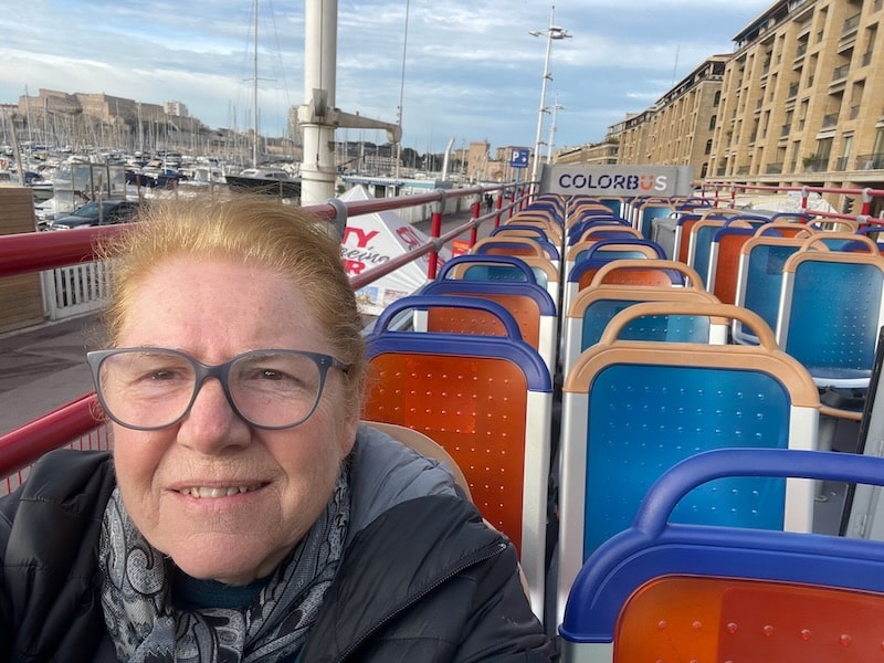 The article's author, Leyla, riding the top of the hop-on hop-off bus, on a cool winter day when the bus is empty.