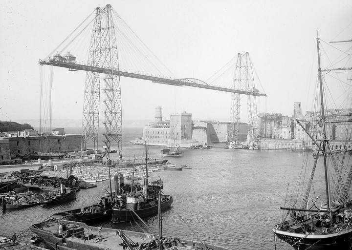 View of Marseille transporter bridge from the shore. The platform that crossed from one shore to another can be seen in the distance.