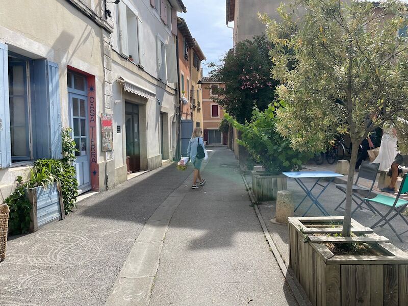 Narrow shady street in Isle sur la Sorgue in Provence Narrow shady street in Isle sur la Sorgue in Provence