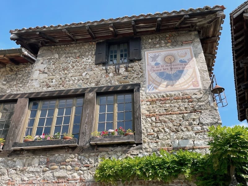 Sundial on house in Place du Tilleul in Perouges, Auvergne-Rhone-Alpes region of France