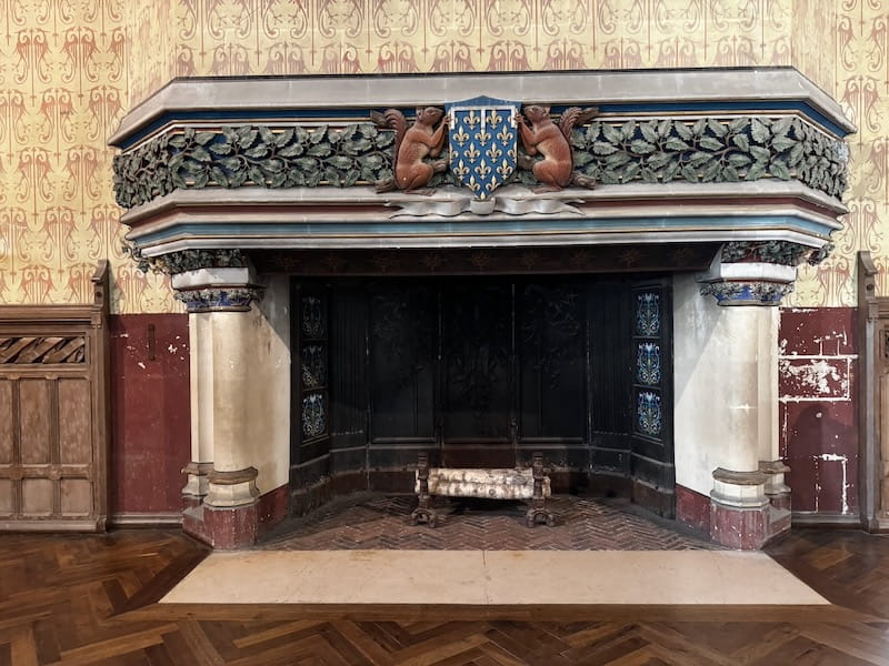 Squirrels on either side of Louis d'Orleans' coat of arms over a large fireplace