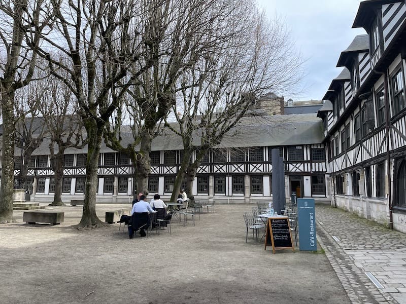 The Aitre Saint-Maclou, once a mass grave, now has a restaurant terrace