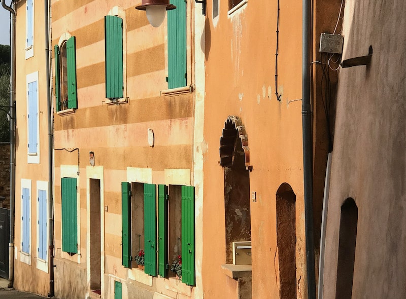 Roussillon's ochre houses, one with green shutters Roussillon's ochre houses, one with green shutters